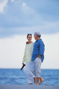 Photo: Happy couple walking on beach